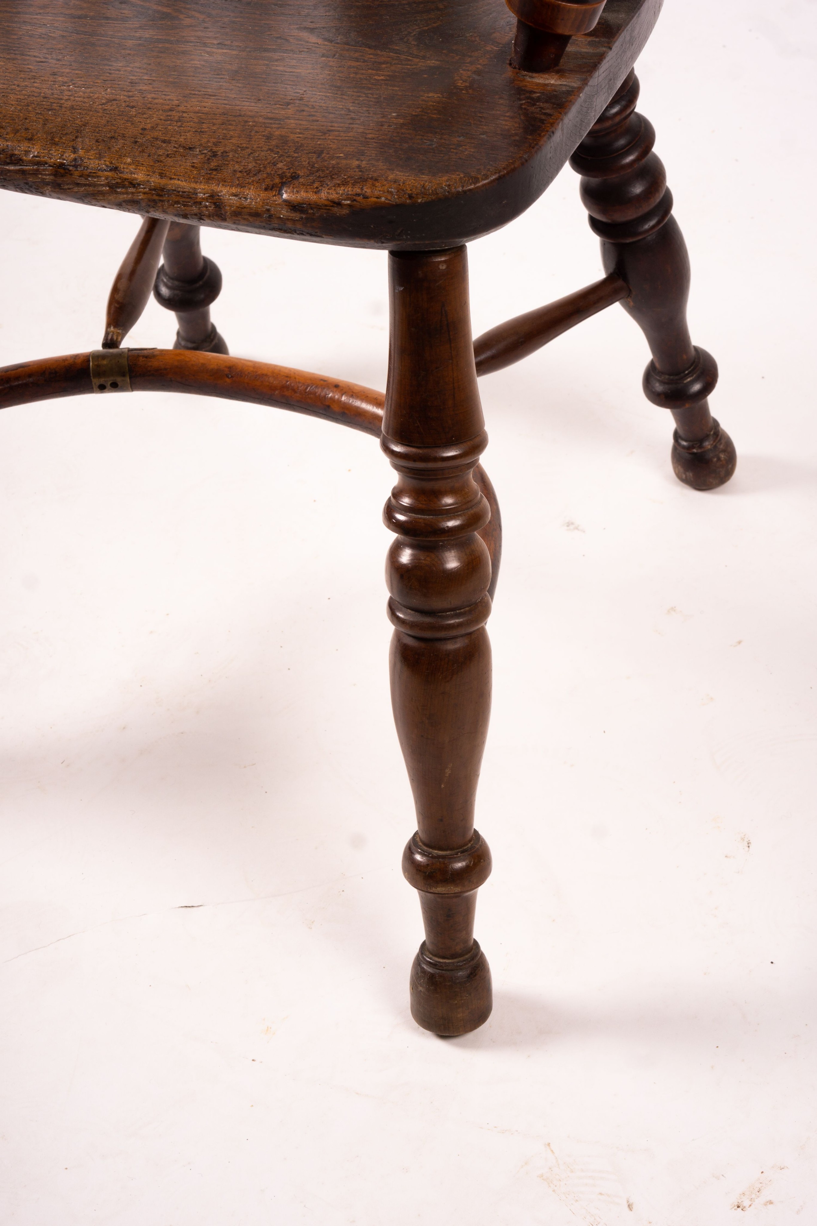 A 19th century yew and elm Yorkshire area Windsor elbow chair with crinoline stretcher, width 60cm, depth 45cm, height 93cm